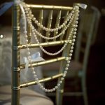 gold tiffany chair with white cushion and white pearls 