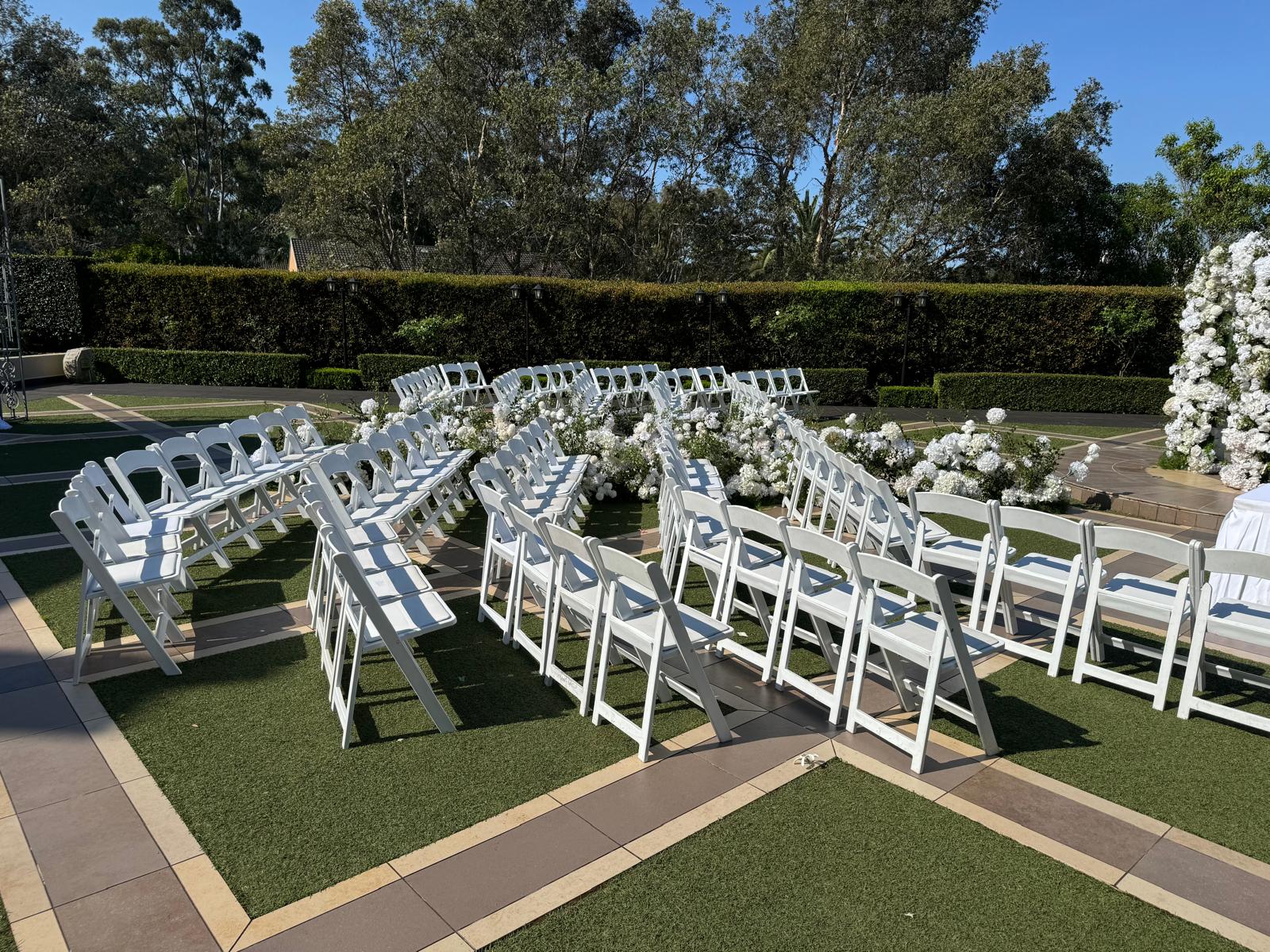 White Padded Folding Chair / White Gladiator Chair white padded folding chairs set up at an outdoor wedding