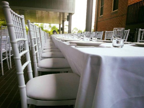 white trestle table and white tiffany chairs 