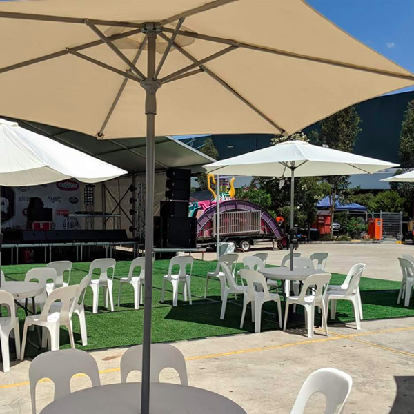 umbrella and white plastic chairs to hire