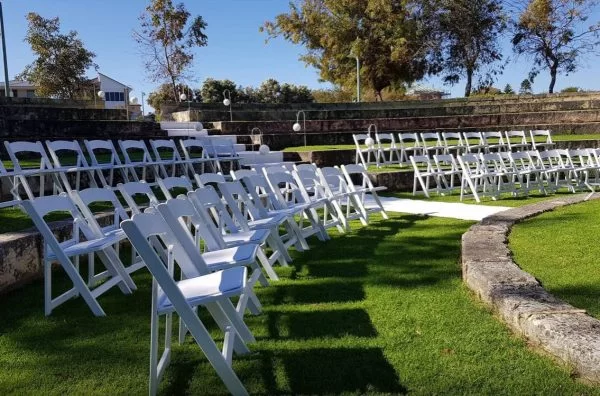 White folding chairs at an outdoor venue