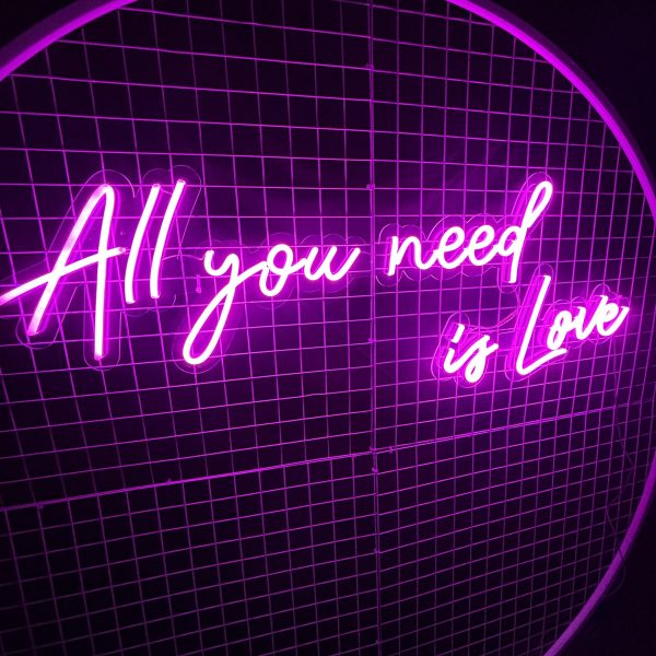 All you need is love neon sign on white backdrop