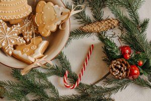 mistletoe on a table with a bowl of cookies and candy cane
