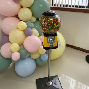 candy machine with balloons in background