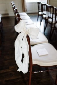 white ribbon on wedding chair